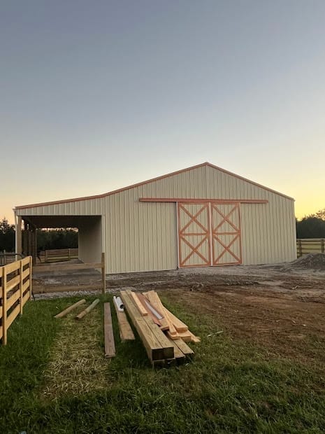 Finished barndominium home with metal siding and covered porch, built in Tennessee